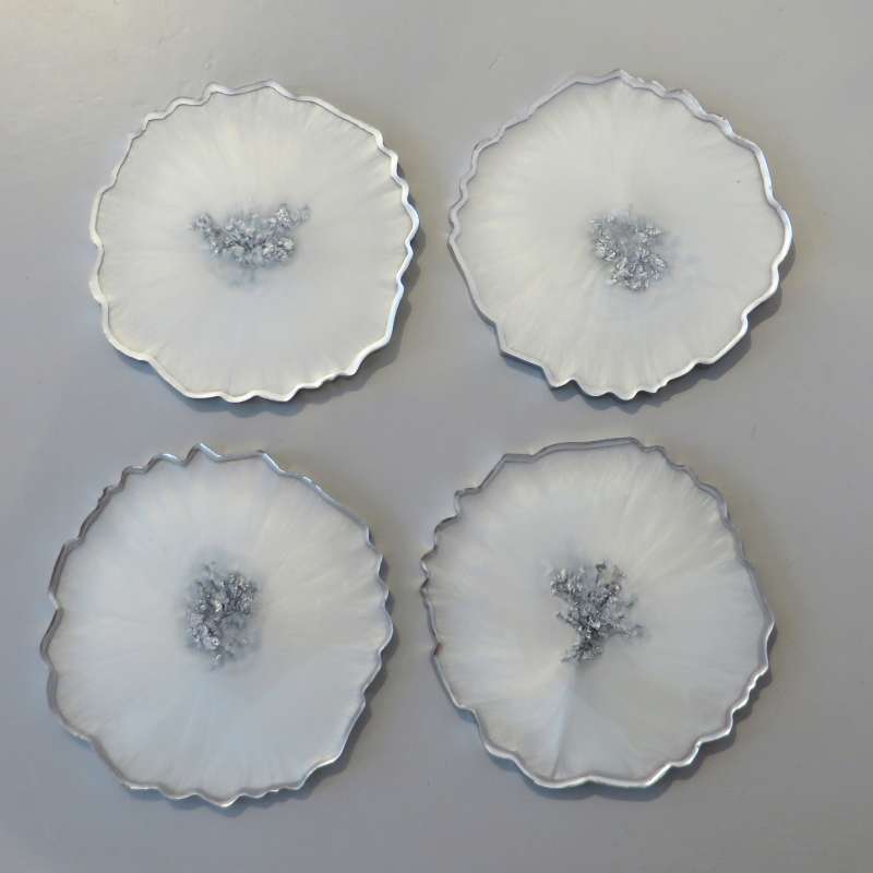 White and silver round coasters
